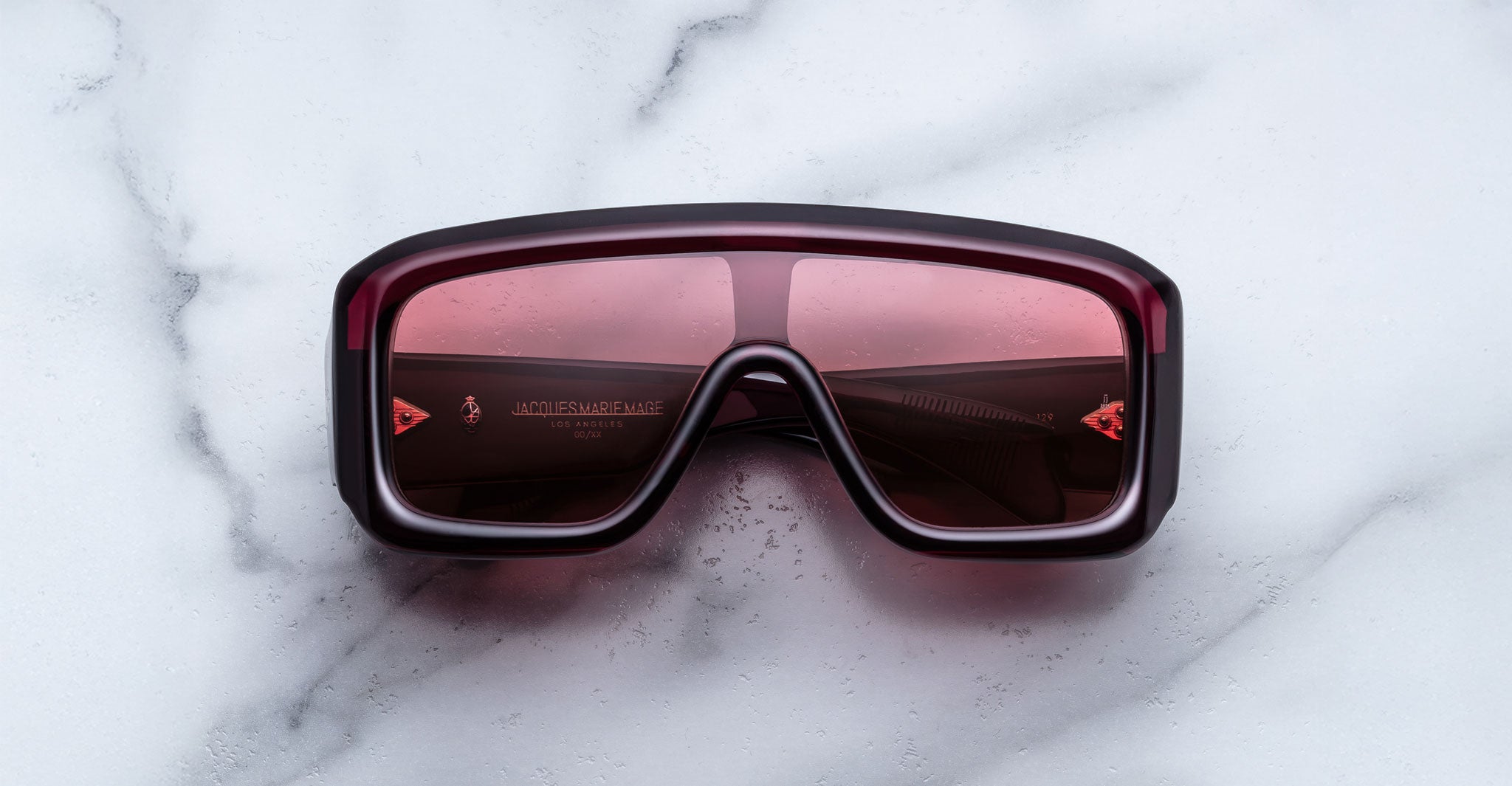 Jacques Marie Mage Pausa sunglasses with red-tinted lenses, top view showing full frame and lens color.