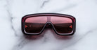 Jacques Marie Mage Pausa sunglasses with red-tinted lenses, top view showing full frame and lens color.
