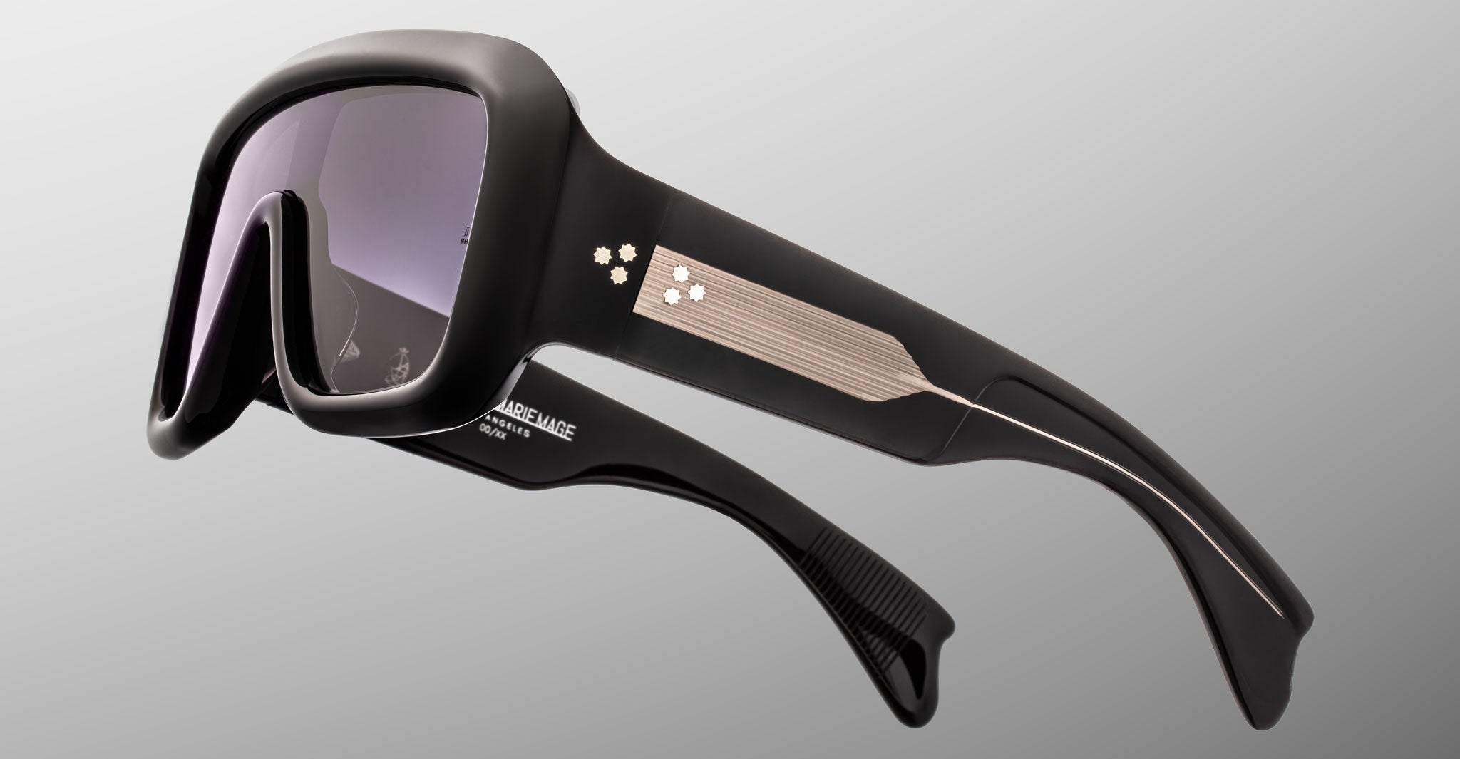 Jacques Marie Mage Pausa black sunglasses, thick frames, silver-accented arms, front and side view visible.