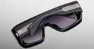 Jacques Marie Mage Pausa sunglasses with bold black frames, silver stripes, and a modern design shown from the front angle.