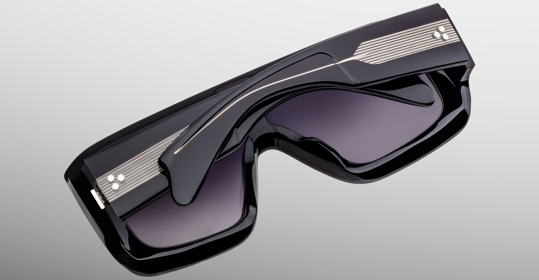 Jacques Marie Mage Pausa sunglasses with bold black frames, silver stripes, and a modern design shown from the front angle.