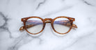 Jacques Marie Mage Percier round tortoiseshell eyeglasses with clear lenses, top view.