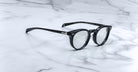 Jacques Marie Mage Percier black-rimmed round acetate eyeglasses, top view, showcasing the frame design and brand details.