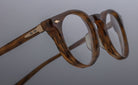 Close-up of Jacques Marie Mage Percier eyeglasses, round tortoiseshell frames, metallic hinges, front angle.