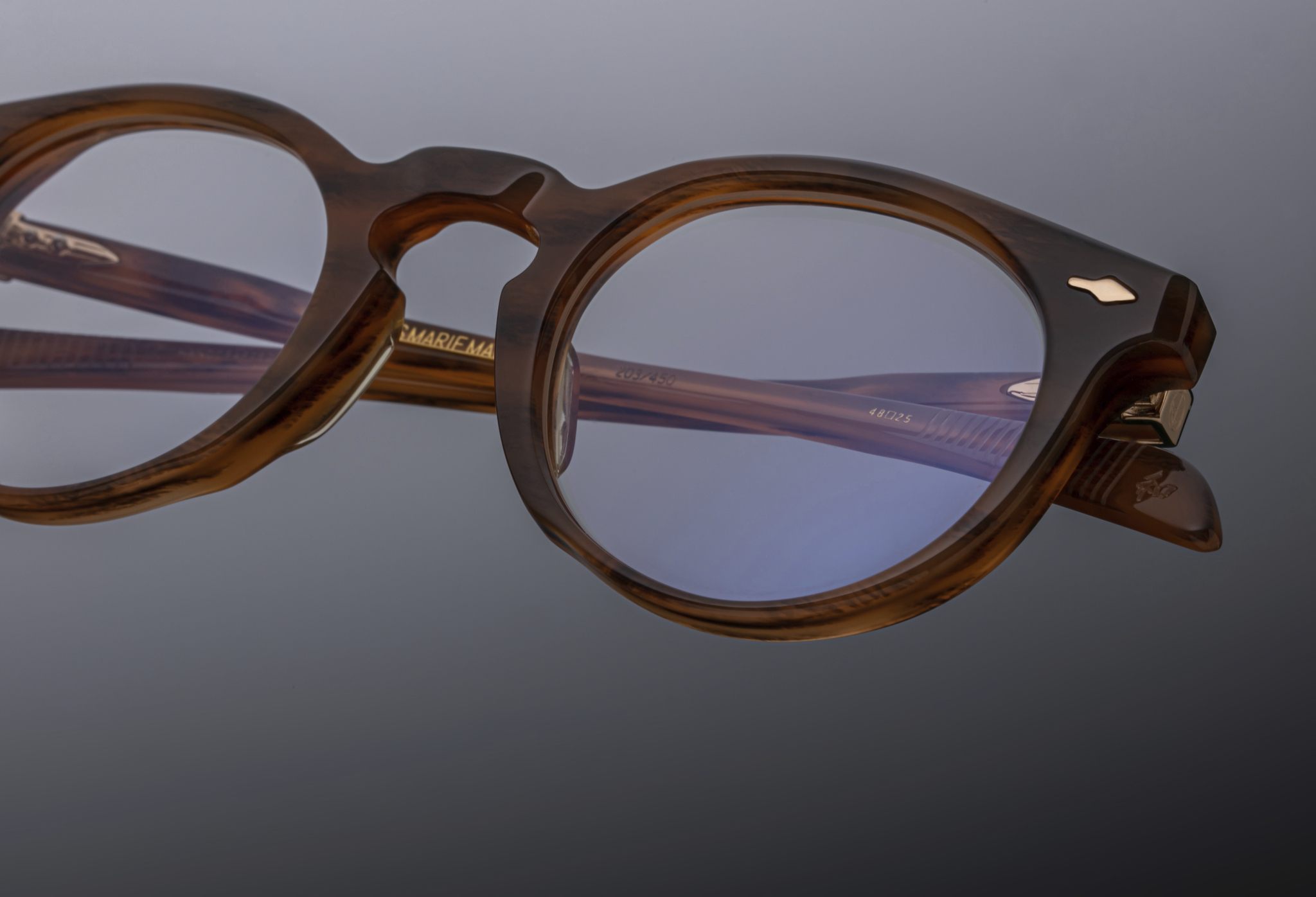 Close-up of Jacques Marie Mage Percier brown round eyeglasses with clear lenses, front angle.