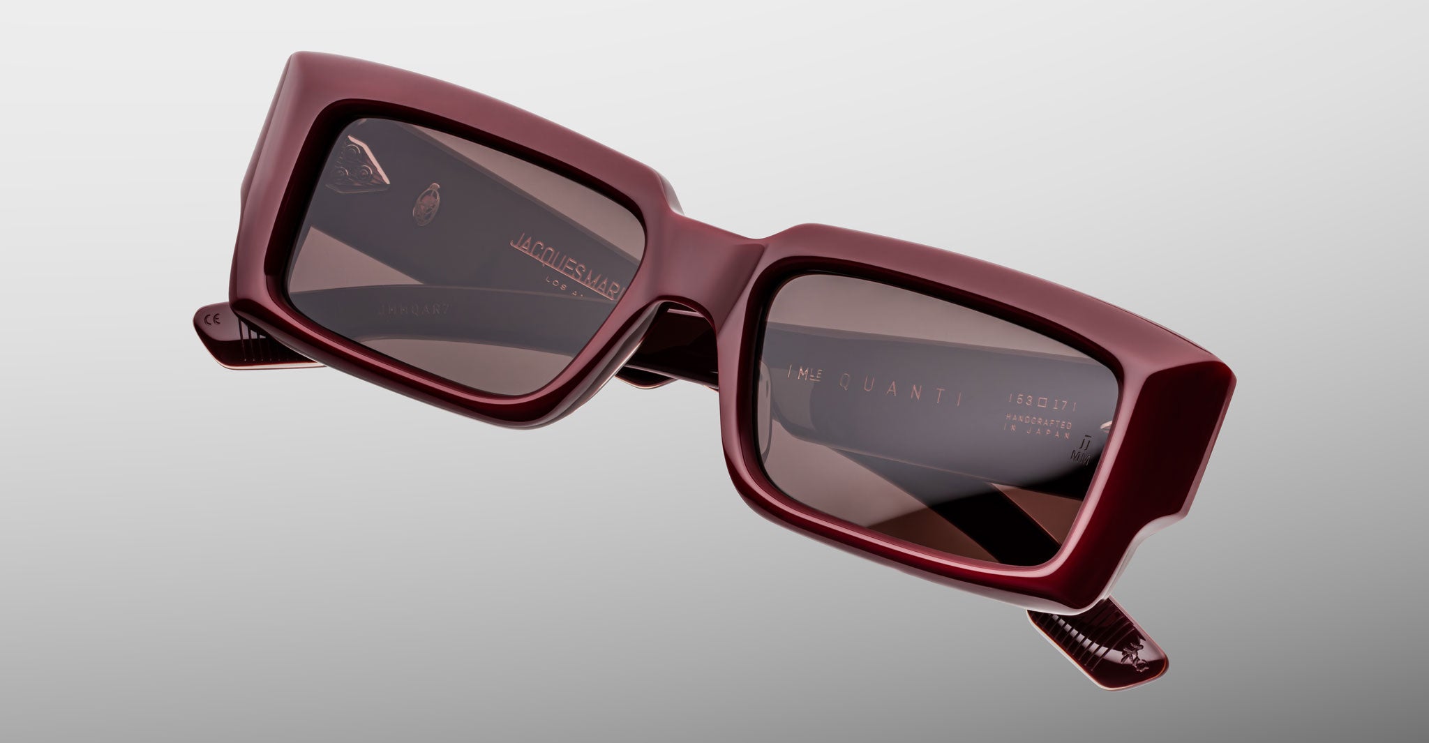 Jacques Marie Mage Quant in Bordeaux Empire, rectangular burgundy acetate sunglasses shown from a close angled front view, featuring bold sculpted rims, wide temples, and softly tinted lenses.