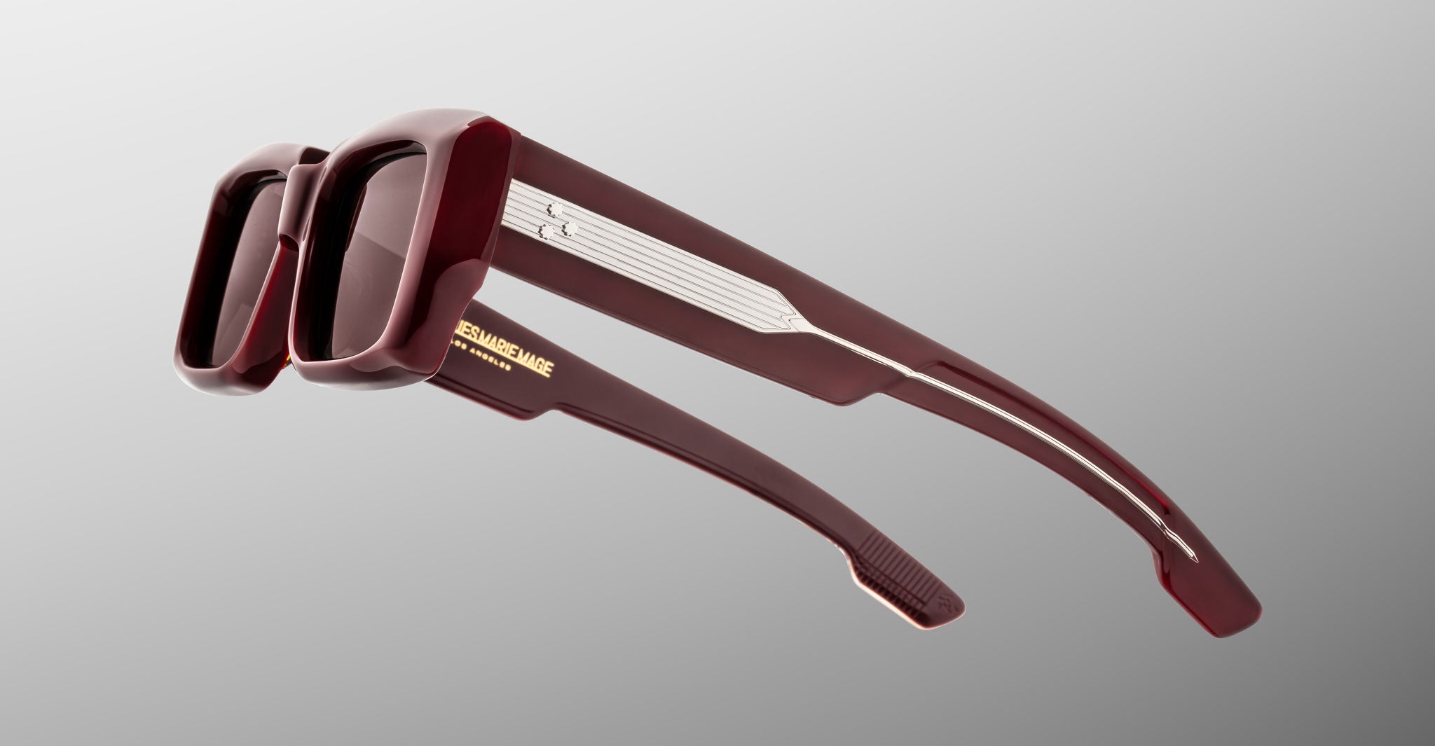 Jacques Marie Mage Quant in Bordeaux Empire, rectangular burgundy acetate sunglasses shown from a rear side angle, highlighting wide temples with signature metal inlay, sculpted temple tips, and softly tinted lenses.