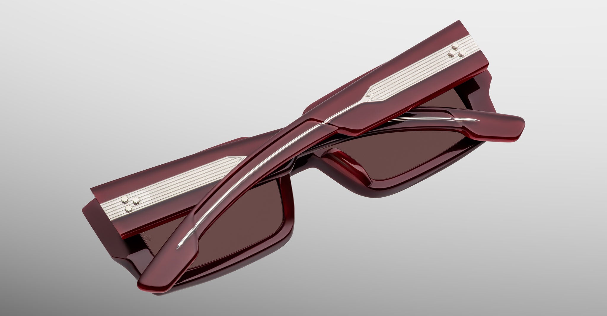 Jacques Marie Mage Quant in Bordeaux Empire, rectangular burgundy acetate sunglasses shown from an angled top view, highlighting wide temples with signature metal inlay, bold sculpted rims, and softly tinted lenses.