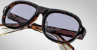 Detailed front view of a pair of Jacques Marie Mage Richard Havana, thick-framed sunglasses with blue lenses on a plain background