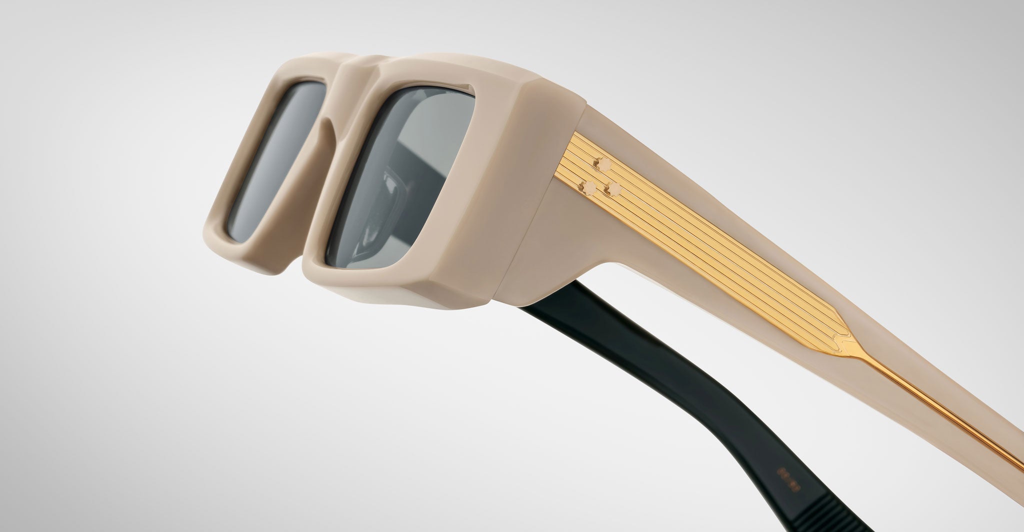 Detailed profile view of the Jacques Marie Mage Rimbaud sunglass in cream color with light grey lenses on a white background