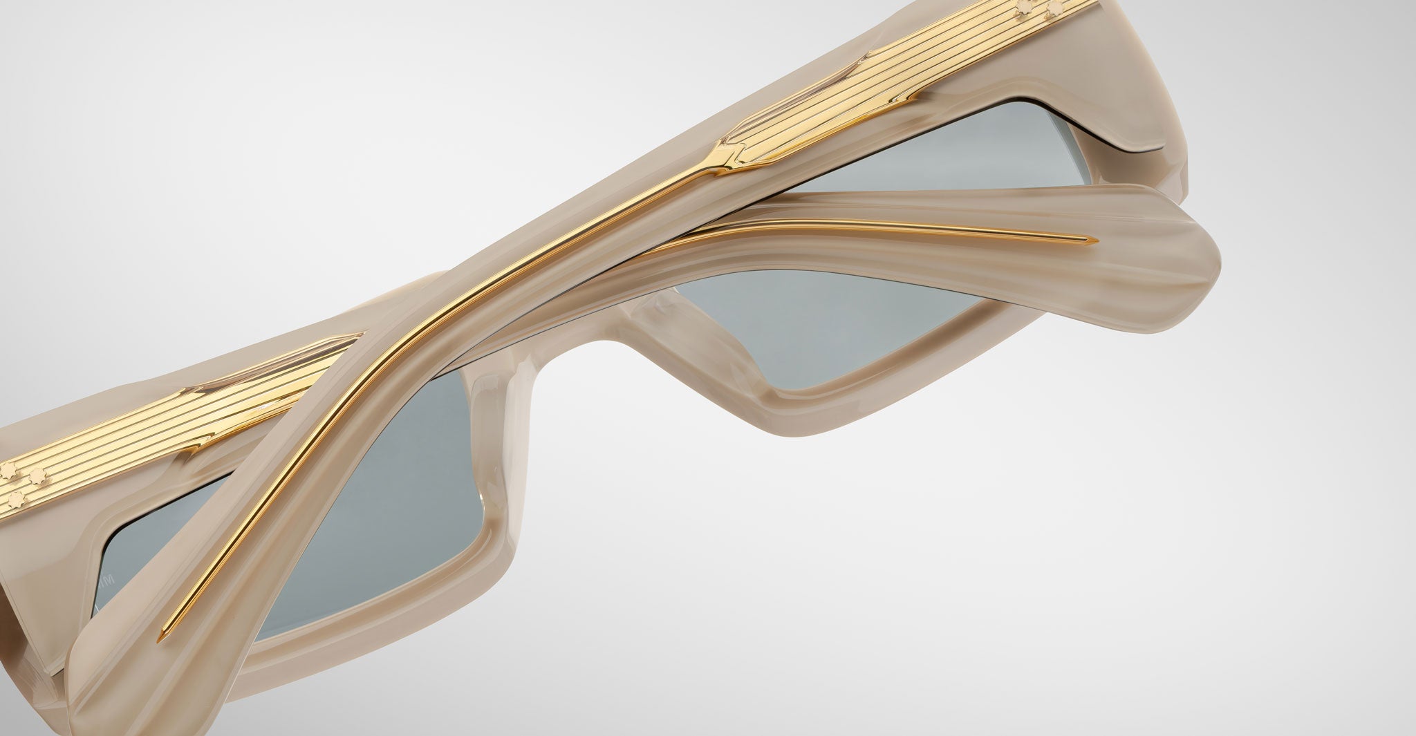 Detailed back view of the Jacques Marie Mage Rimbaud sunglass in cream color with light grey lenses on a white background