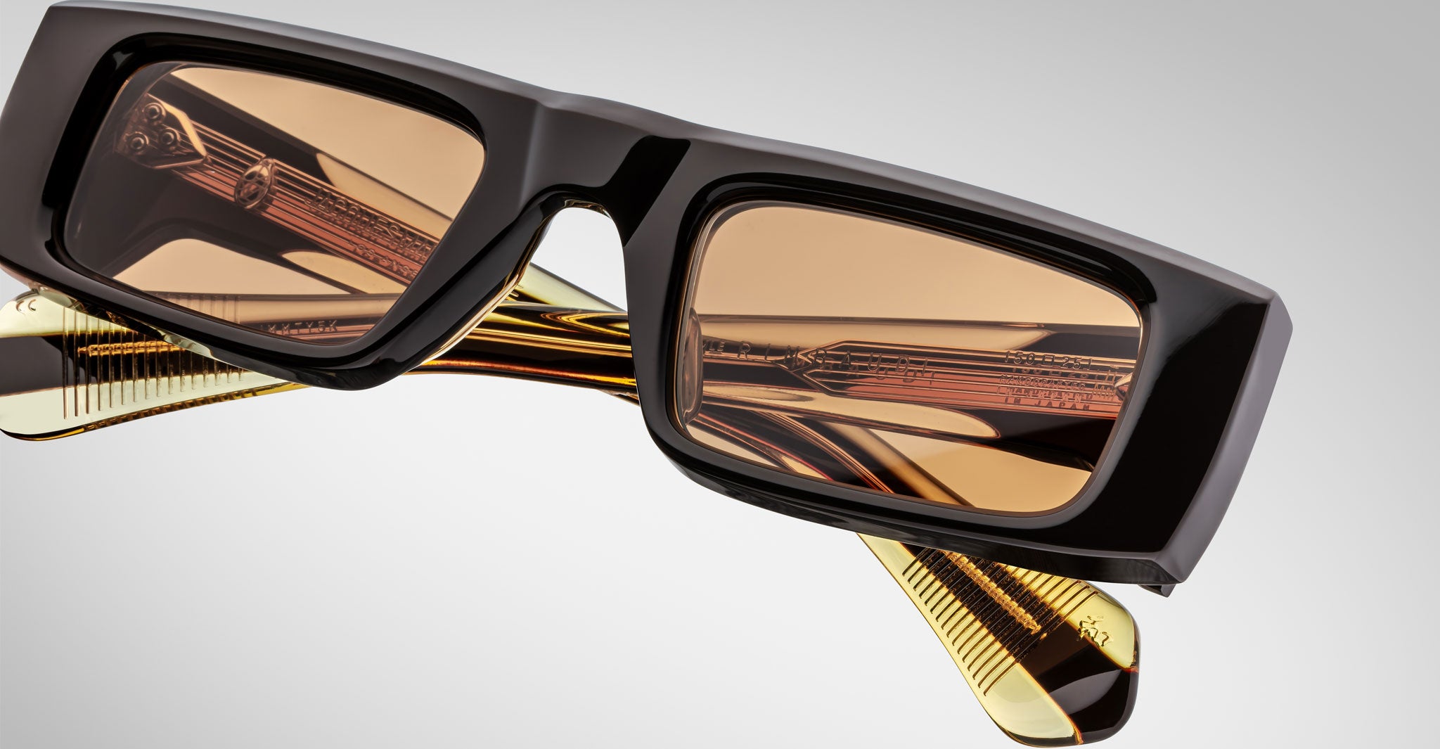 Close-up view of the Jacques Marie Mage Rimbaud sunglass in walnut color with orange lenses on a white background