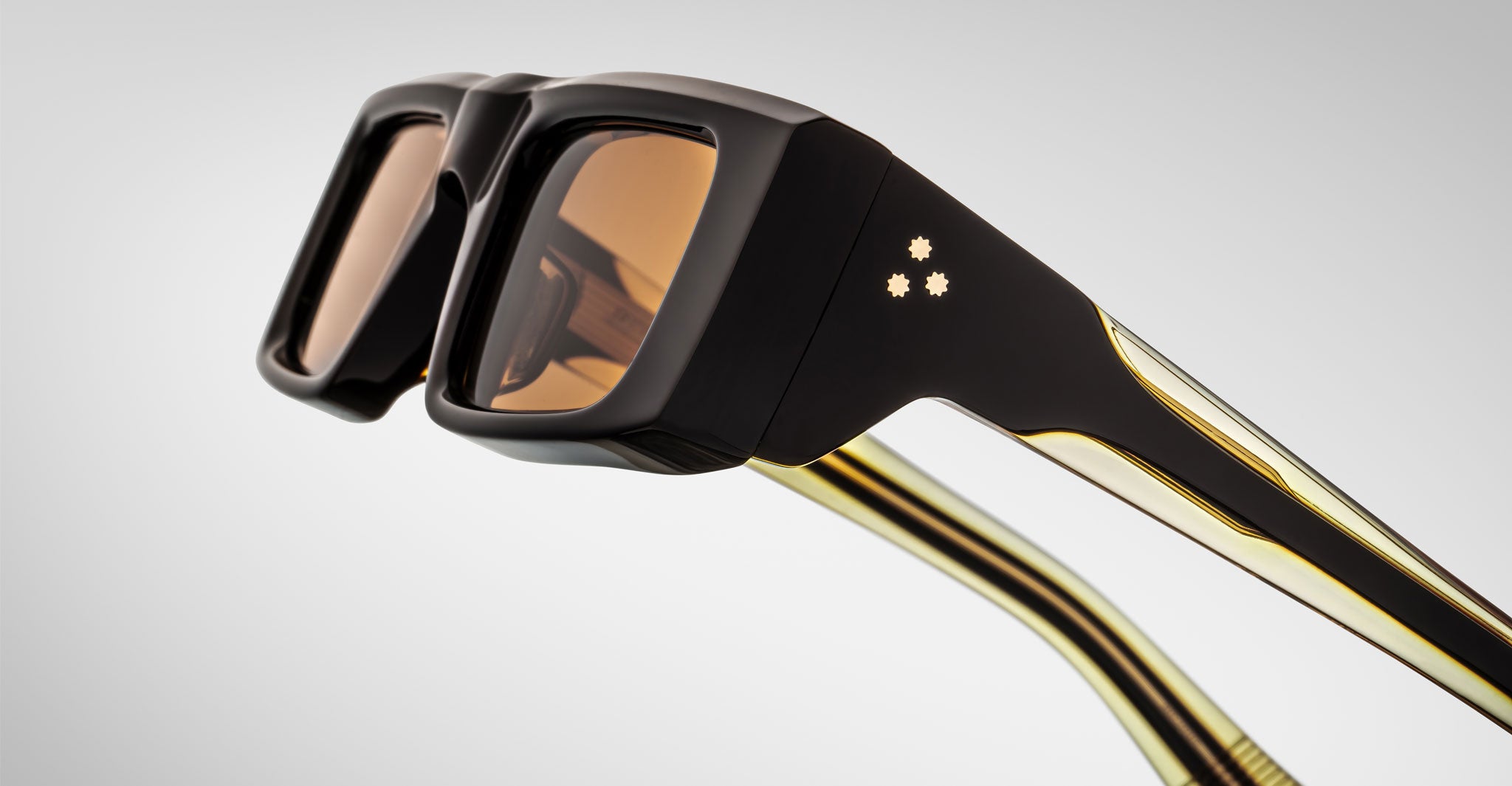 Close-up profile view of the Jacques Marie Mage Rimbaud sunglass in walnut color with orange lenses on a white background