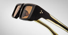 Close-up profile view of the Jacques Marie Mage Rimbaud sunglass in walnut color with orange lenses on a white background