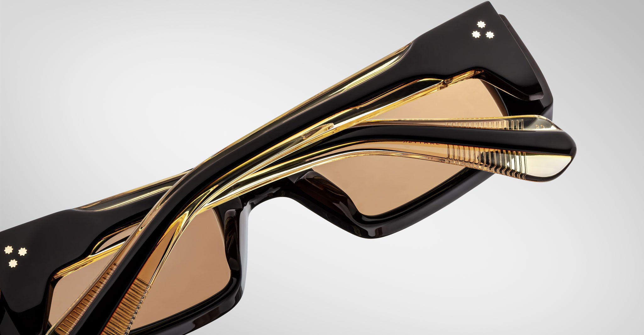 Close-up back view of the Jacques Marie Mage Rimbaud sunglass in walnut color with orange lenses on a white background