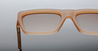Close-up of the top half of Jacques Marie Mage Rush rectangular sunglasses, featuring light brown translucent frames and gradient tinted lenses, set against a neutral background.