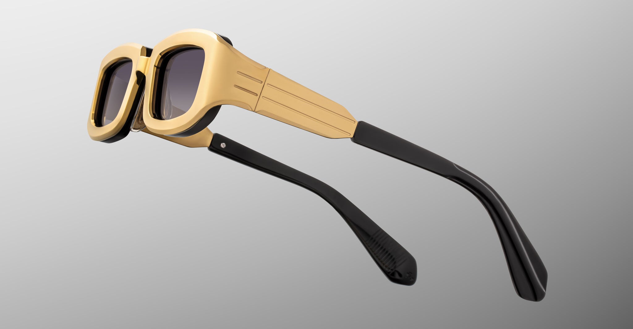 Jacques Marie Mage Ryder in Gold, rectangular gold-tone acetate sunglasses shown from a rear side angle, highlighting wide temples with stepped detailing, sculpted temple tips, and gradient tinted lenses.