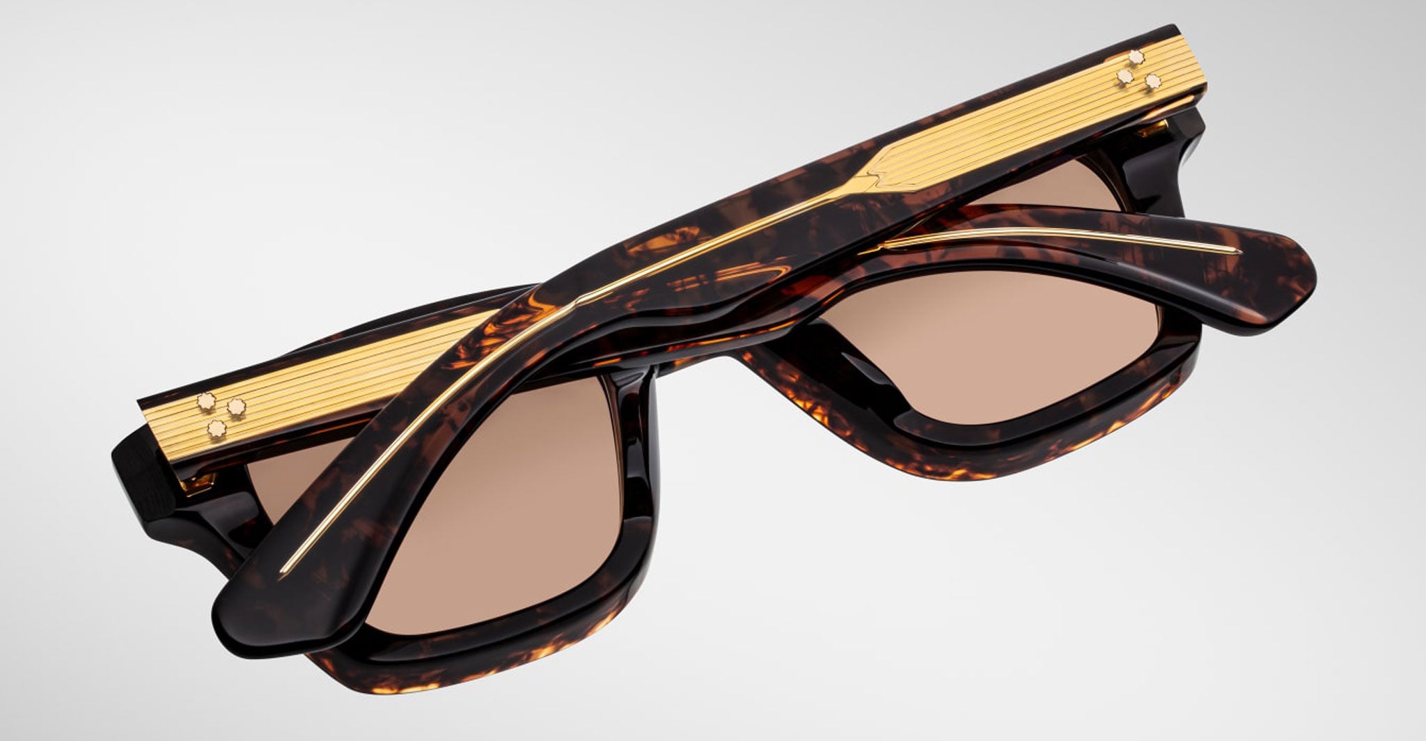 Jacques Marie Mage Sonata sunglasses, folded, overhead view highlighting gold-detailed temples.
