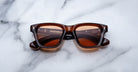 Jacques Marie Mage Sonata sunglasses with rectangular frames and tinted lenses, viewed from above.