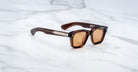 Jacques Marie Mage Sonata brown rectangular sunglasses with tinted lenses and silver accents, front view.