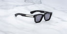 Jacques Marie Mage Sonata black sunglasses with UV-protective dark lenses and silver detailing, front view.