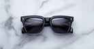 Jacques Marie Mage Torino in Hudson rectangular dark blue sunglasses with dark lenses, top-view angle.