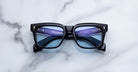 Jacques Marie Mage Torino in Obscure black rectangular eyeglasses with blue-tinted lenses, front view.