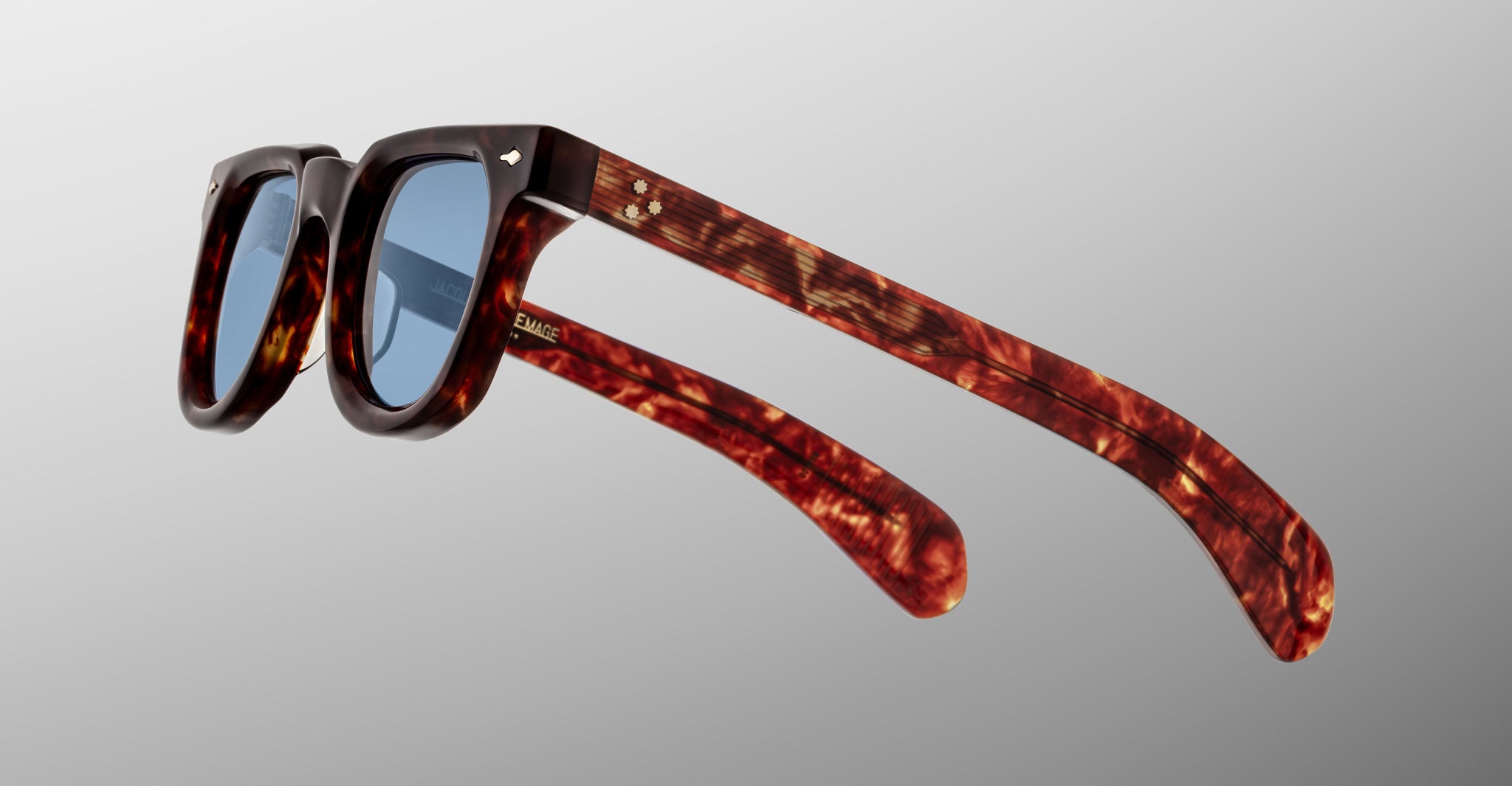 Jacques Marie Mage Vendome sunglasses in brown tortoiseshell with blue lenses, displayed from the side against a plain light gray background.