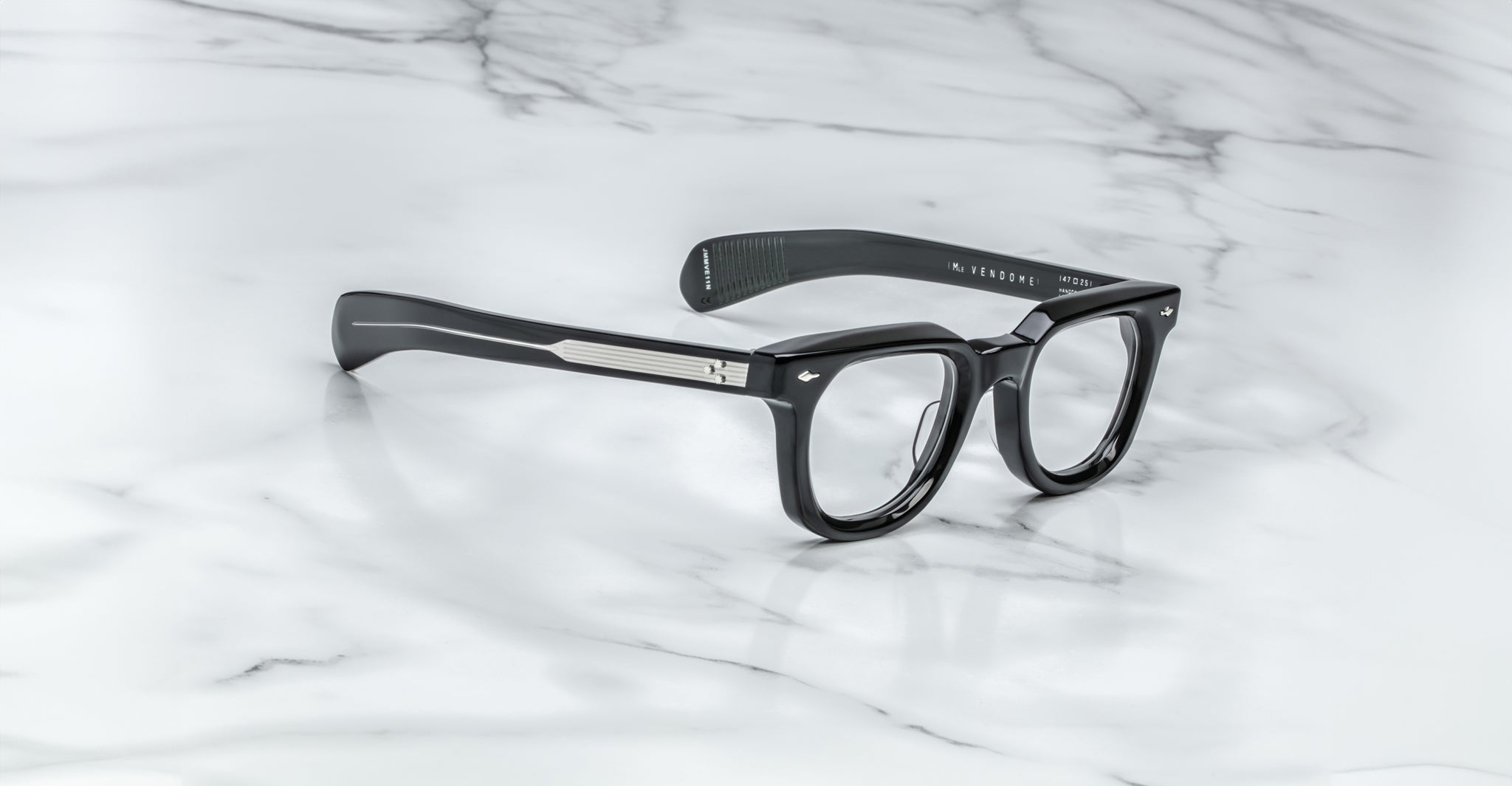 Jacques Marie Mage Vendome black rectangular optical frames with thick temples and silver accents, handcrafted in Japan by Jacques Marie Mage, displayed on a white marble surface.