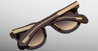 Jacques Marie Mage Vendome in Ganache sunglasses, folded, dark brown frame with gold detailing on arms, back angle view.