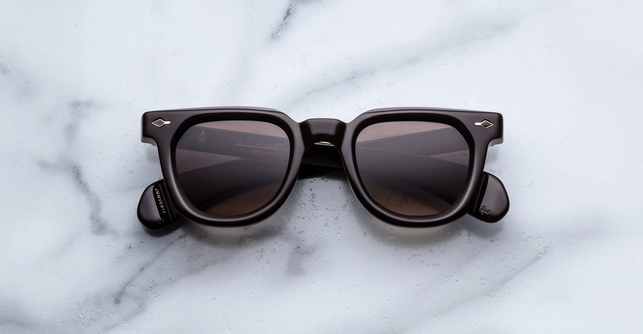 Jacques Marie Mage Vendome in Ganache square-framed sunglasses with black frames and dark lenses, top-down view.