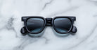 Jacques Marie Mage Vendome black square-framed sunglasses with dark lenses, handcrafted in Japan, displayed on a white marble surface.