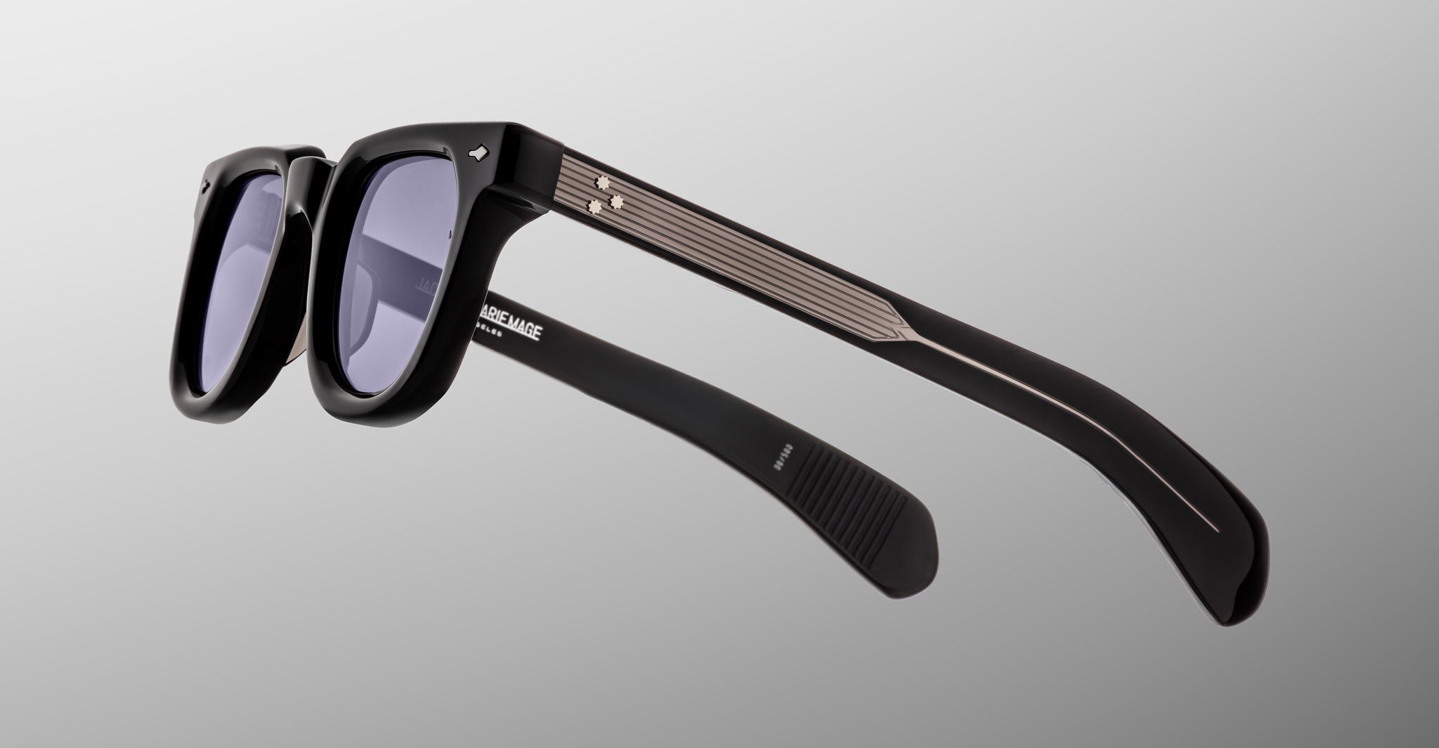 The Jacques Marie Mage Vendome sunglasses feature black rectangular thick frames, dark lenses, and silver temple accents. Handcrafted in Japan, these iconic shades are shown against a light gray background.