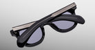 A pair of Jacques Marie Mage Vendome sunglasses with folded arms, handcrafted in Japan, by Jacques Marie Mage, displayed on a light gray background.
