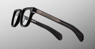 Jacques Marie Mage Vendome optical frames feature black rims, clear lenses, and silver temple accents, handcrafted in Japan by Jacques Marie Mage, displayed on a neutral gradient background.