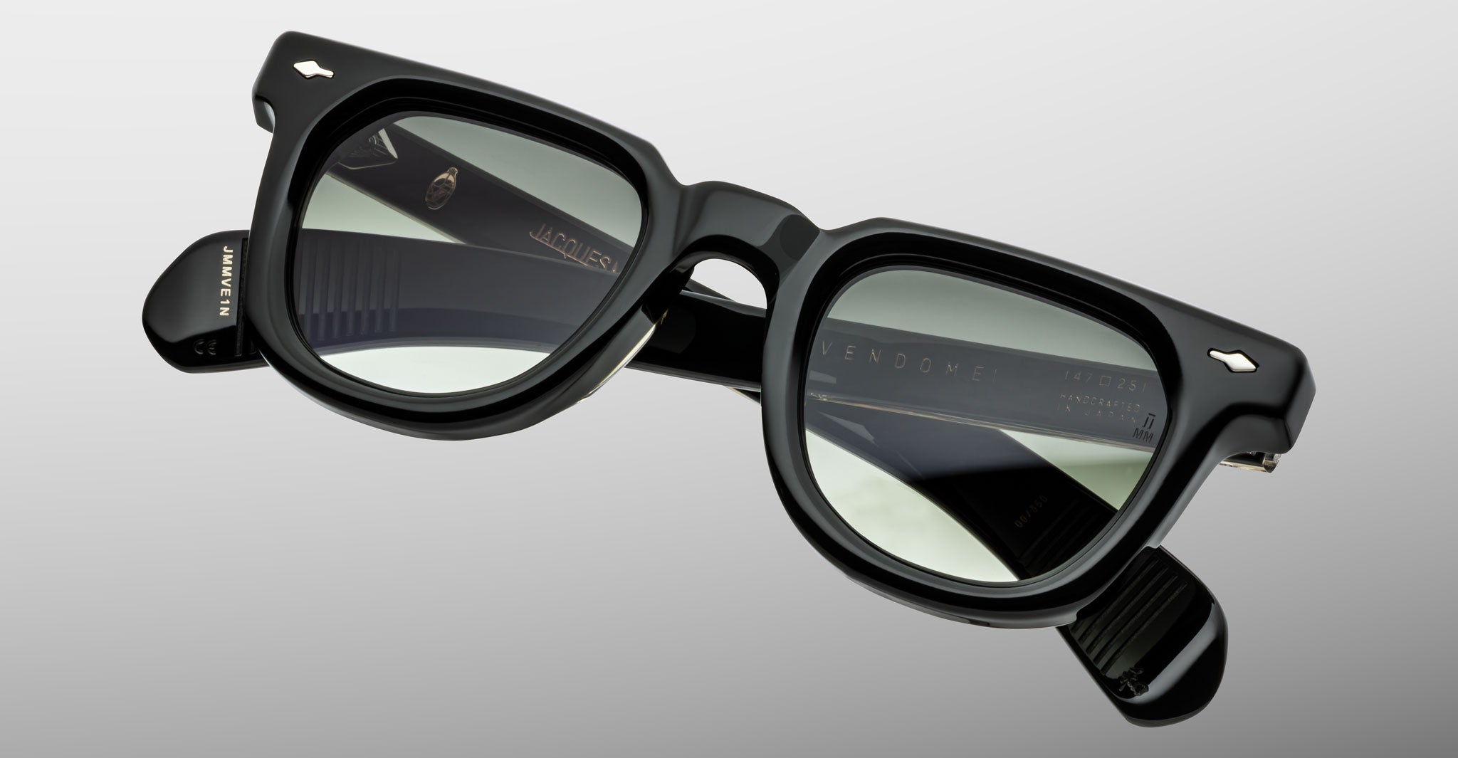 Close-up of Jacques Marie Mage Vendome rectangular sunglasses in black, featuring thick frames and grey-tinted lenses. Expertly handcrafted in Japan, these sunglasses showcase Jacques Marie Mage’s commitment to superior quality.