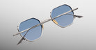 Jacques Marie Mage Verlaine sunglasses with hexagonal blue gradient lenses and silver frames, front view shown.