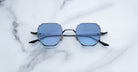Jacques Marie Mage Verlaine sunglasses, blue hexagonal lenses, thin black frames, front view.