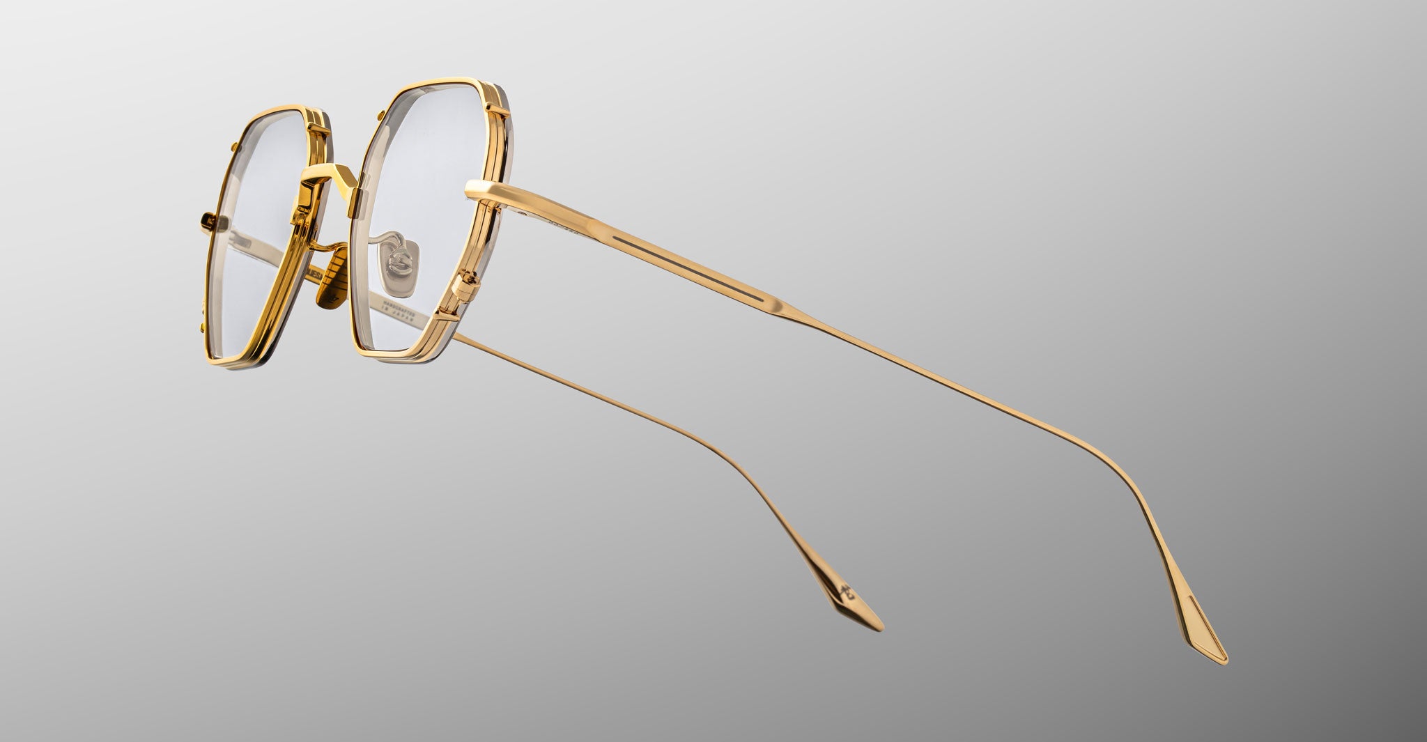 Jacques Marie Mage Verlaine gold metal eyeglasses with clear lenses, shown in side profile.