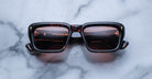 Jacques Marie Mage Walker sunglasses with dark lenses, viewed from above.
