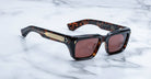 Jacques Marie Mage Walker sunglasses with brown UV lenses shown from above, featuring thick frames.