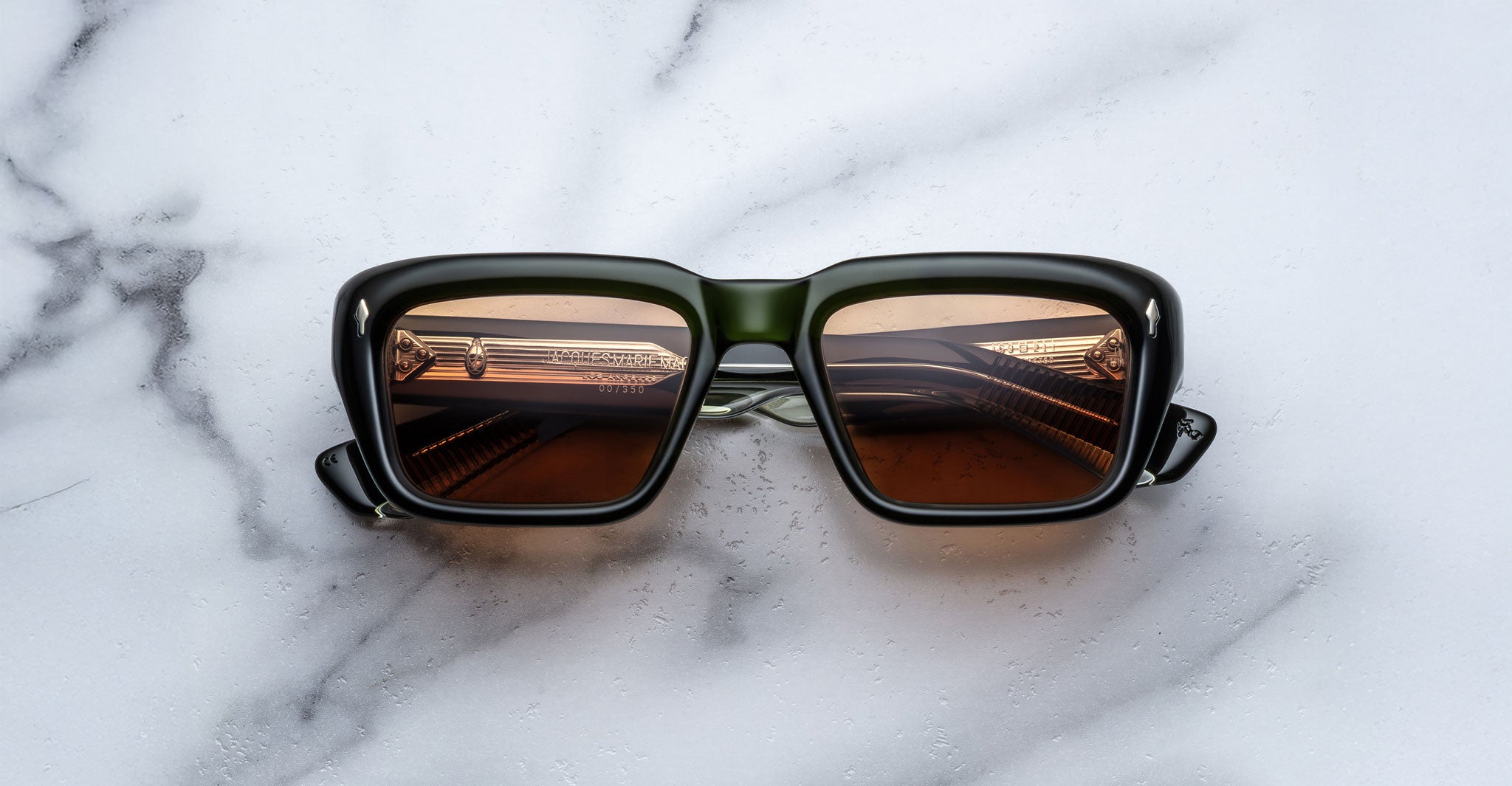 Jacques Marie Mage Walker black rectangular sunglasses with polarized brown lenses, shown from above.