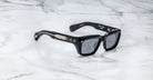 Jacques Marie Mage Walker black rectangular sunglasses with silver-accented arms, top down view.