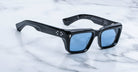 Jacques Marie Mage Walker rectangular black sunglasses with blue lenses, top view.