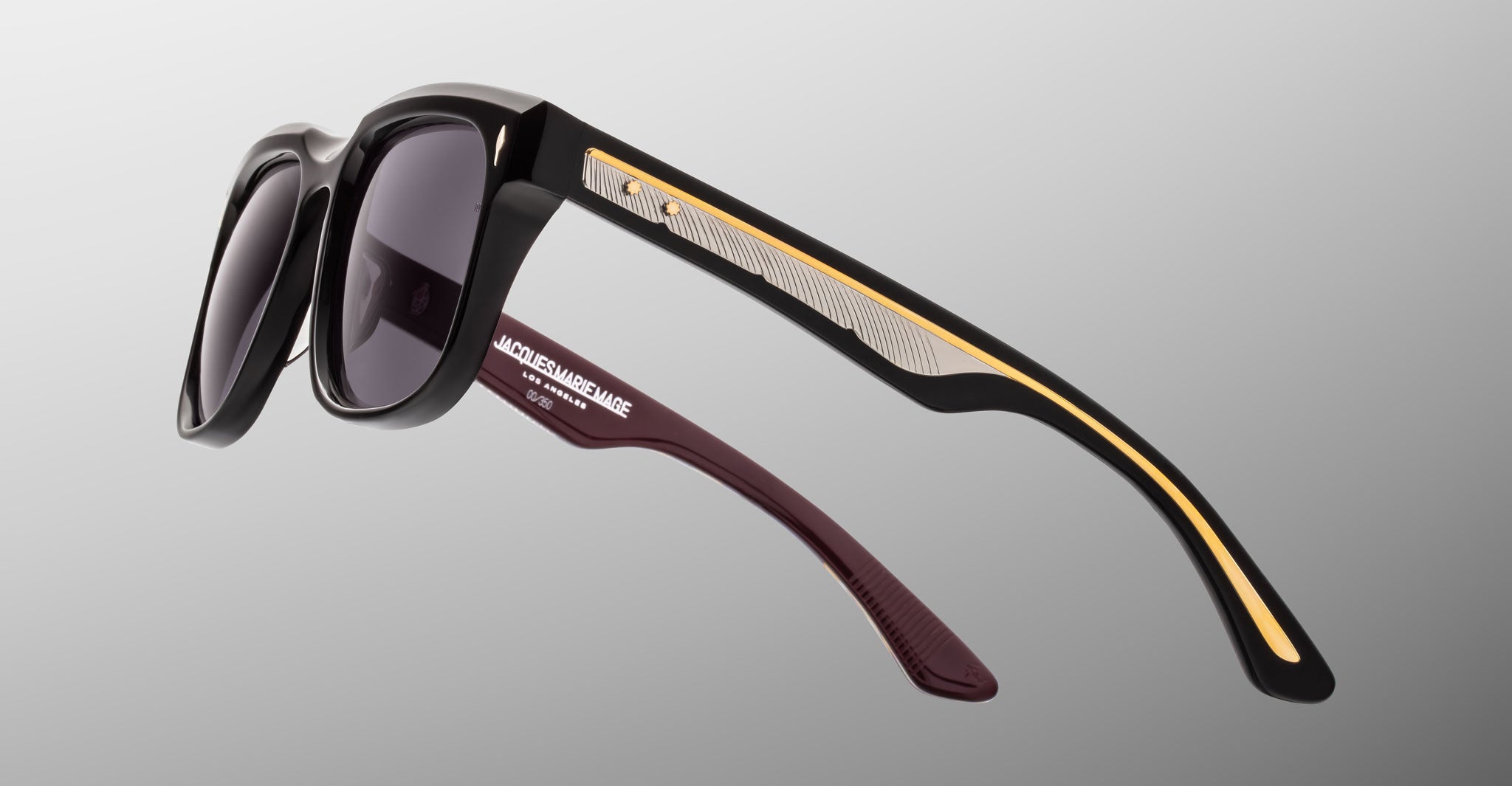 Jacques Marie Mage Wesley black sunglasses with gold and silver arms, shown from the front angle.