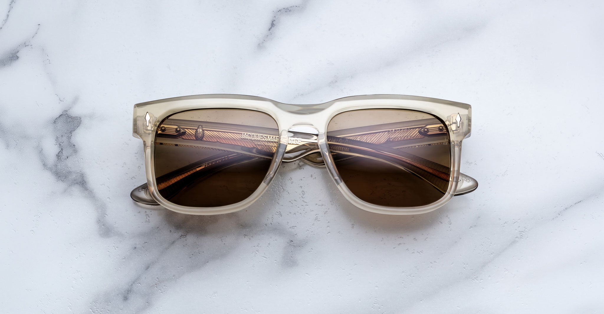 Jacques Marie Mage Wesley sunglasses, clear frames, brown lenses, top view.
