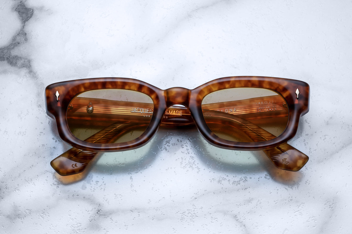 Jacques Marie Mage Whiskeyclone tortoiseshell rectangular sunglasses with green UV-protected lenses, front view.