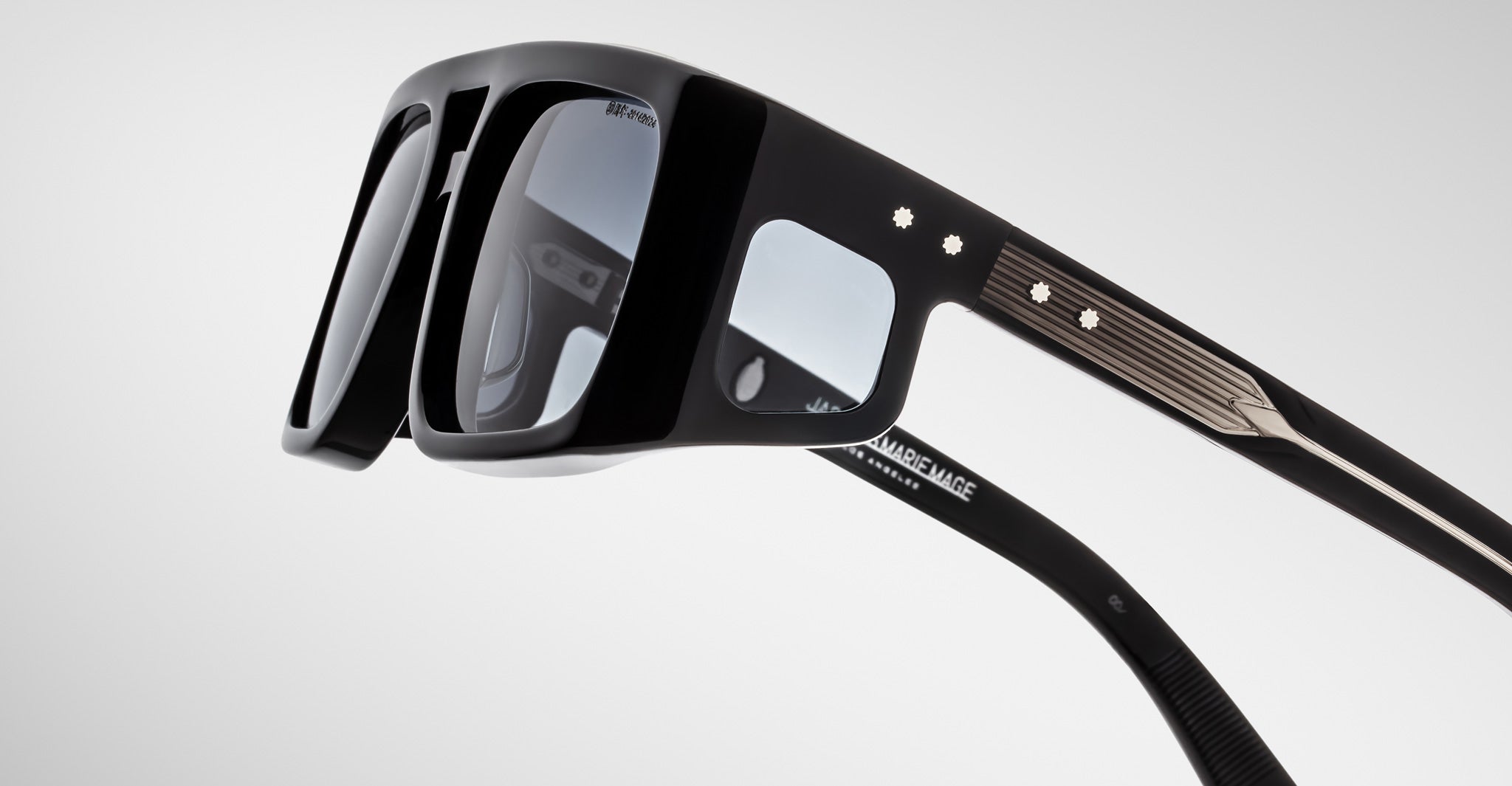 Close-up of Jacques Marie Mage Windsor black smart eyeglasses showing camera lenses and sensors in the frame.
