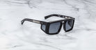 Jacques Marie Mage Windsor black rectangular sunglasses with thick frames, viewed from above.