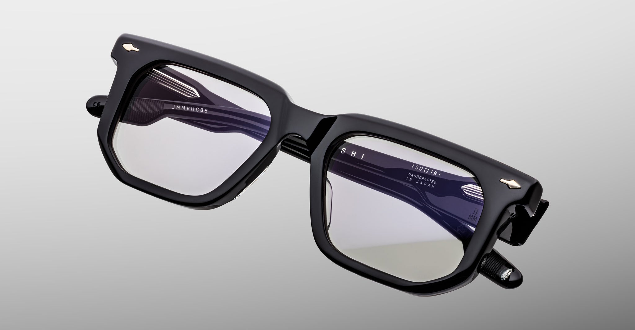 Jacques Marie Mage Yoshi in Black acetate optical frame close-up angled view with geometric lens shape and arrowhead pins